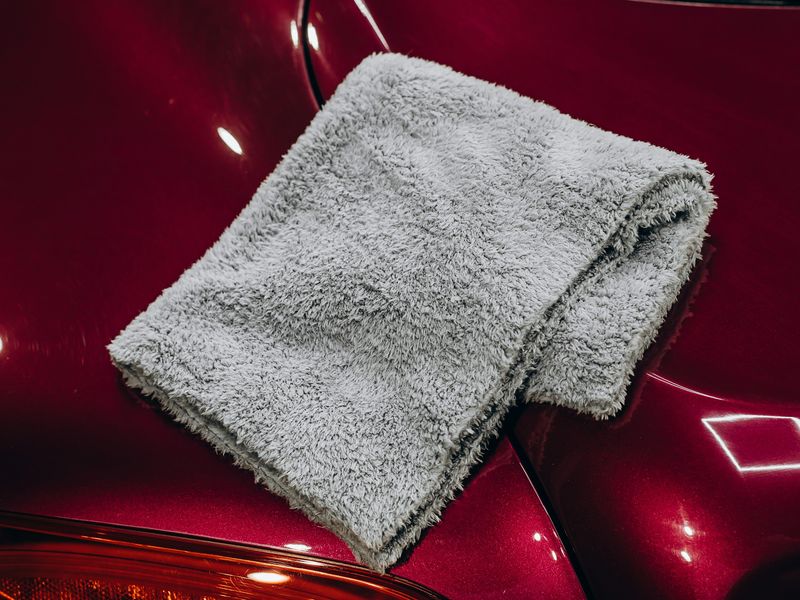 Microfiber towel resting on freshly polished car paint
